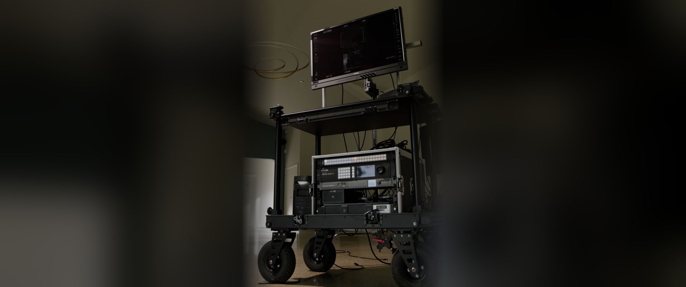 DIT cart with a monitor, video routing and storage rack